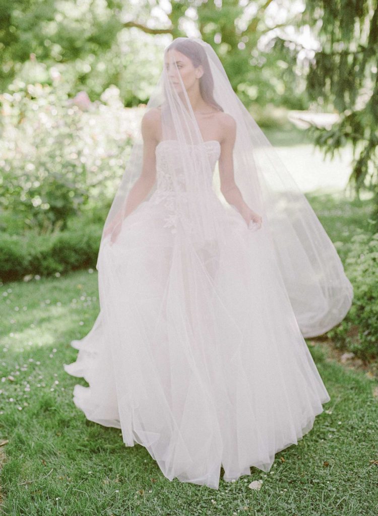 bride walking through beautiful green garden